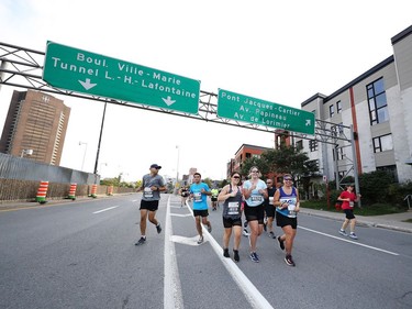 Runners on St-Antoine St. during the Oasis International Marathon de Montreal - Day 2 on September 22, 2019 in Montreal.