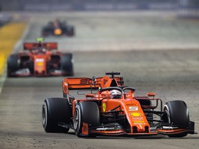 Sebastian Vettel of Germany driving the (5) Scuderia Ferrari SF90 leads Charles Leclerc of Monaco driving the (16) Scuderia Ferrari SF90 on track during the F1 Grand Prix of Singapore at Marina Bay Street Circuit on September 22, 2019 in Singapore.