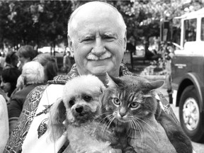 Canon Horace Baugh holds Fanny, 7, a miniature French poodle, and Yasmine, 4, an Angora cat at his annual blessing of the pets at Beaver Lake on Mount Royal Sept. 25, 1983. This photo appeared in the Montreal Gazette the following day.