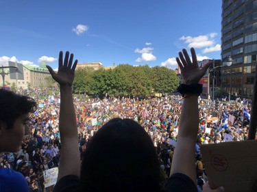 An enthusiastic show of support from a balcony overlooking a throng of people joining the Greta Thunberg-led climate march along Parc Ave. in Montreal on Friday, Sept. 27, 2019.