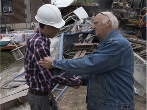 A man named Don (right) offers his condolences and help to the husband of the owner of Deli-Pat on Friday, Sept. 6, 2019, in N.D.G. after the business was suddenly demolished.