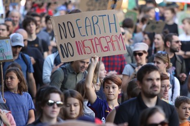 A boy holds up a sign during big climate march in Montreal Friday September 27, 2019.