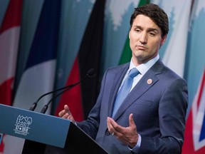 Justin Trudeau addresses a news conference at the G7 summit in La Malbaie in June 2018. His Liberals are about 15 percentage points ahead of their closest rivals in Quebec, according to the latest polls.