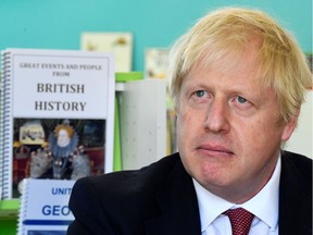 Britain's Prime Minister Boris Johnson speaks with year four and year six pupils during a visit to Pimlico Primary school in London on September 10, 2019.