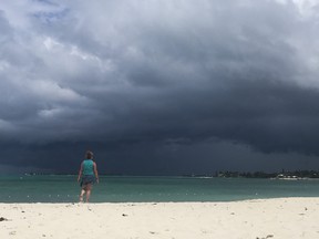 A woman walks on the beach as a storm approaches in Nassau, Bahamas, on Sept. 12, 2019. (ANDREW CABALLERO-REYNOLDS/AFP/Getty Images)
