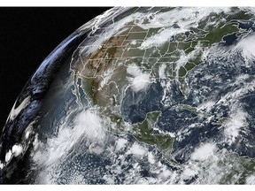 This satellite image obtained from NOAA/RAMMB, shows Hurricane Lorena, left, on Thursday, Sept. 19, 2019, as it made landfall on the southwest coast of Mexico.