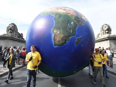 BUDAPEST, HUNGARY: Protesters march with a globe balloon on the oldest Hungarian bridge, the Lanchid, during the Global Climate Strike Sept. 27, 2019.