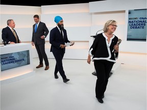 Green Party leader Elizabeth May walks off the set past Conservative leader Andrew Scheer and New Democratic Party (NDP) leader Jagmeet Singh after the Maclean's/Citytv National Leaders Debate on the second day of the election campaign in Toronto, Ontario, Canada September 12, 2019. Picture taken September 12, 2019. Frank Gunn/Pool via REUTERS