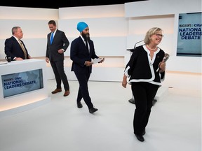 Green Party leader Elizabeth May walks off the set past Conservative leader Andrew Scheer and New Democratic Party (NDP) leader Jagmeet Singh after the Maclean's/Citytv National Leaders Debate on the second day of the election campaign in Toronto, Ontario, Canada September 12, 2019. Picture taken September 12, 2019. Frank Gunn/Pool via REUTERS