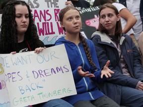 Swedish activist Greta Thunberg, centre, seen in front of UN headquarters in New York on Sept. 6, will participate in the Montreal climate-crisis march next week.