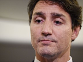 Liberal Leader Justin Trudeau reacts as he makes a statement in regards to photo coming to light of himself from 2001 wearing "brownface" during a scrum on his campaign plane in Halifax, N.S., on Wednesday, Sept. 18, 2019.