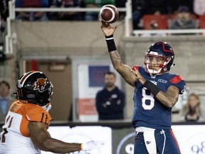 Alouettes quarterback Vernon Adams Jr. fires a pass as BC Lions defensive-end Odell Willis tries to reach him during the first quarter at Molson Stadium on Friday night, Sept. 6, 2019.