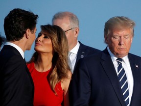 First Lady Melania Trump kisses Canada's Prime Minister Justin Trudeau next to the U.S. President Donald Trump during the family photo with invited guests at the G7 summit in Biarritz, France, August 25, 2019.