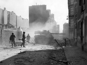 A U.S. tank destroyer fires at a Nazi bunker location to clear a path through a side street in Brest, France, in September 1944.