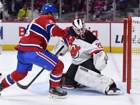 New Jersey Devils' Mackenzie Blackwood stops a shot by Montreal Canadiens forward Nick Cousins during the first period at the Bell Centre on Sept. 16, 2019.