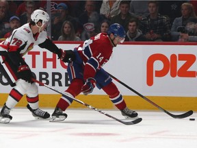 Canadiens' Nick Suzuki plays the puck against Senators defenceman Thomas Chabot at the Bell Centre on Saturday, Sept. 28, 2019.