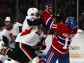 Canadiens' Brendan Gallagher is checked by Ottawa Senators defenceman Mark Borowiecki at Bell Centre on Saturday, Sept. 28, 2019,