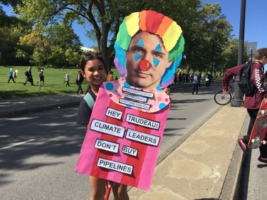 Heidi Bangalina carries sign to big climate march in Montreal Friday September 27, 2019.
