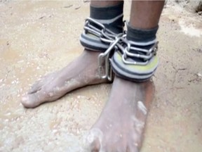 A person with chained ankles is pictured after being rescued from a building in the northern city of Kaduna, Nigeria September 26, 2019, in this grab obtained from a video.