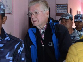 Canadian Ernest Fenwick MacIntosh, accused of sexually abusing a Nepalese child, is escorted by police for his appearance at the District Court in Lalitpur on February 5, 2015. (PRAKASH MATHEMA/AFP/Getty Images) Na030215-conviction