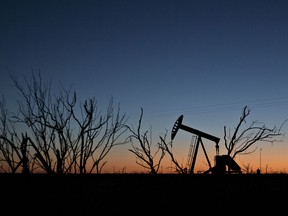 The silhouette of a pumpjack is seen at dusk in the Permian Basin.