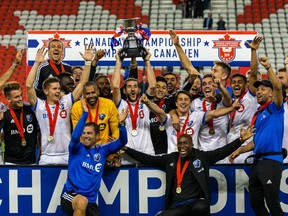 Montreal Impact midfielder Ignacio Piatti (10) lifts the Voyageurs Cup after defeating the Toronto FC at BMO Field.