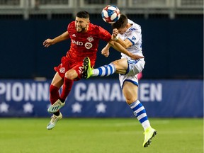 Toronto FC midfielder Jonathan Osorio battles for the ball against Montreal Impact defender Jukka Raitala, right, during the second half of the Canadian Championship at BMO Field in Toronto on Sept. 25, 2019.