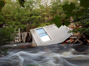 A river flows with debris which destroyed a fishing shed after the departure of Hurricane Dorian in Halifax, Nova Scotia, Canada September 8, 2019. Picture taken with long exposure. REUTERS/John Morris