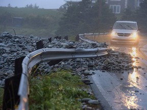 In Nova Scotia, a guard rail was damaged by powerful waves that drove rocks on shore in Cow Bay Sept. 7, 2019. Hurricane Dorian brought wind, rain and heavy seas that knocked out power across the region and left damage to buildings and trees.