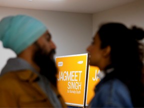 A campaign sign sits in the corner as New Democratic Party (NDP) leader Jagmeet Singh talks with his wife Gurkiran Kaur Sidhu as he stops by the NDP election office on Election Day in Burnaby, British Columbia, Canada October 21, 2019.