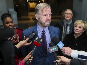 Geoffrey Chambers, president of the Quebec Community Groups Network, speaks to reporters after a meeting with Quebec Premier Francois Legault in Montreal Friday February 15, 2019.  With Chambers are, from left, Tiffany Callender, executive director at the Cote des Neiges Black Community Association, left, QCGN vice president Gerald Cutting and director general Sylvia Martin-Laforge.