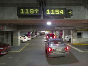 Electronic signs in the parking lot on the MUHC's Glen site indicate where parking spots are available in 2015. Under new regulations, patients and visitors in outlying regions will pay as low as $7 a day in hospital parking, while Montreal hospitals are expected to charge a maximum daily rate of $10.