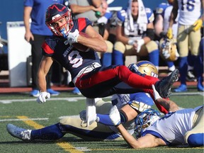 Montreal Alouettes' Jake Wieneke is brought down by Winnipeg Blue Bombers during first half in Montreal on Sept. 21, 2019.