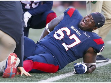 Alouettes offensive lineman Tony Washington cries out in pain after injuring his leg against the Calgary Stampeders in Montreal on Saturday, Oct. 5, 2019.
