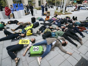 Climate action group Extinction Rebellion members stage a die-in outside the Internation Civil Aviation Organization headquarters in Montreal on Sept. 24, 2019.  They were drawing attention to air pollution and greenhouse gases produced by the aviation industry.