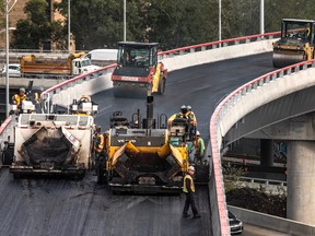 Workers pave the Highway 20 east link to the Décarie Expressway in October 2019.