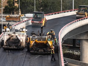 Workers pave the Highway 20 east link to the Décarie Expressway on Friday, October 4, 2019. It was expected to be reopened on Monday.