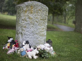 Toys and mementos are placed around a common grave for babies in Mount Royal Cemetery. "For those of us who have suffered a miscarriage, stillbirth, had a newborn die, or lost a baby to SIDS, any public awareness about what frequently remains a matter of private grieving is comforting beyond measure," Deborah Ostrovsky writes.