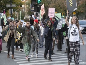 Climate change activists from Extinction Rebellion do a pyjama walk on the corner of Mont-Royal and Parc Aves. Wednesday evening.