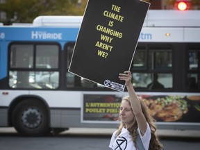 Climate change activist from Extinction Rebellion with her protest banner, as she stands on Park av on Wednesday October 9, 2019. They crossed the intersection of Park and Mont Royal carrying posters and banners to raise awareness about climate change. (Pierre Obendrauf / MONTREAL GAZETTE) ORG XMIT: 63273 - 5783