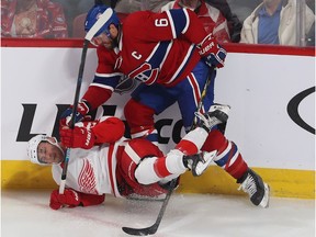 Canadiens' Shea Weber brings down Detroit Red Wings' Taro Hirose in Montreal on Oct. 10, 2019.