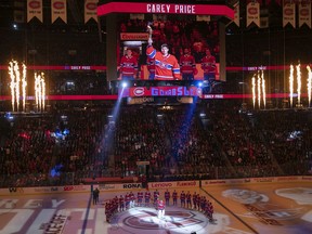 Montreal Canadiens goaltender Carey Price raises torch during the opening ceremonies prior to Montreal's home opener at the Bell Centre against the Detroit Red Wings on Thursday, Oct. 10, 2019.