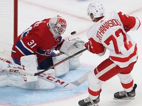 Montreal Canadiens goaltender Carey Price stops puck on Detroit Red Wings' Andreas Athanasiou during second period in Montreal on Thursday, Oct. 10, 2019.
