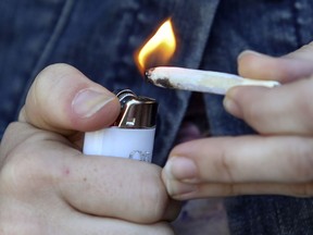 "Angele," a regular cannabis user, lights a joint in Montreal on Oct. 11, 2019.