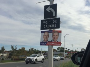 An election poster for the right-leaning People's Party of Canada hangs next to a left turn traffic sign in Pointe-Claire.