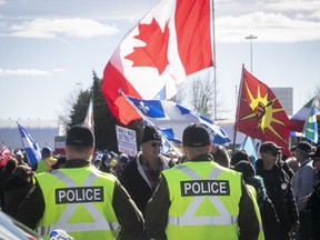 SQ police look over the protest from far-right groups holding a gathering near the St-Bernard-de- Lacolle border post on Saturday Oct. 19, 2019.