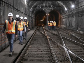 Jean-Philippe Pelletier, far left, deputy-director of work co-ordination for the REM, walks reporters out of the Mount Royal tunnel in October 2018.