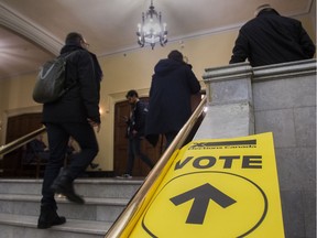 People enter the polling station at Victoria Hall in Westmount to vote in the Notre-Dame-de-Grâce-Westmount riding in the Westmount area of Montreal Monday, October 21, 2019.