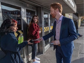 Bloc candidate for the Hochelaga - Maisonneuve riding, Simon Marchand, at the Joliette Metro station in Montreal on Monday October 21, 2019, reminds Daniela Ramirez Rodriguez and Sabrina Jarry, left to right, to vote Bloc. Dave Sidaway / Montreal Gazette ORG XMIT: 63327