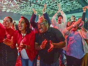 Supporters cheer television projection of a Liberal government at Liberal election headquarters at the Palais des congrès.